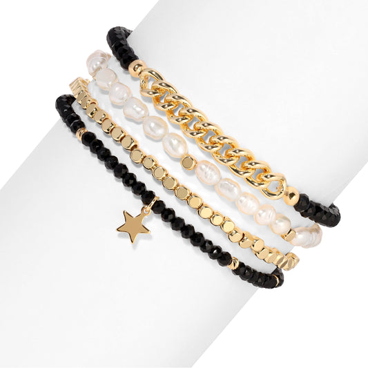 stacked gold and pearl bracelets with star charm