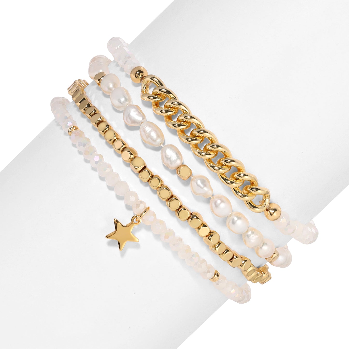 stacked gold and pearl bracelets on white background