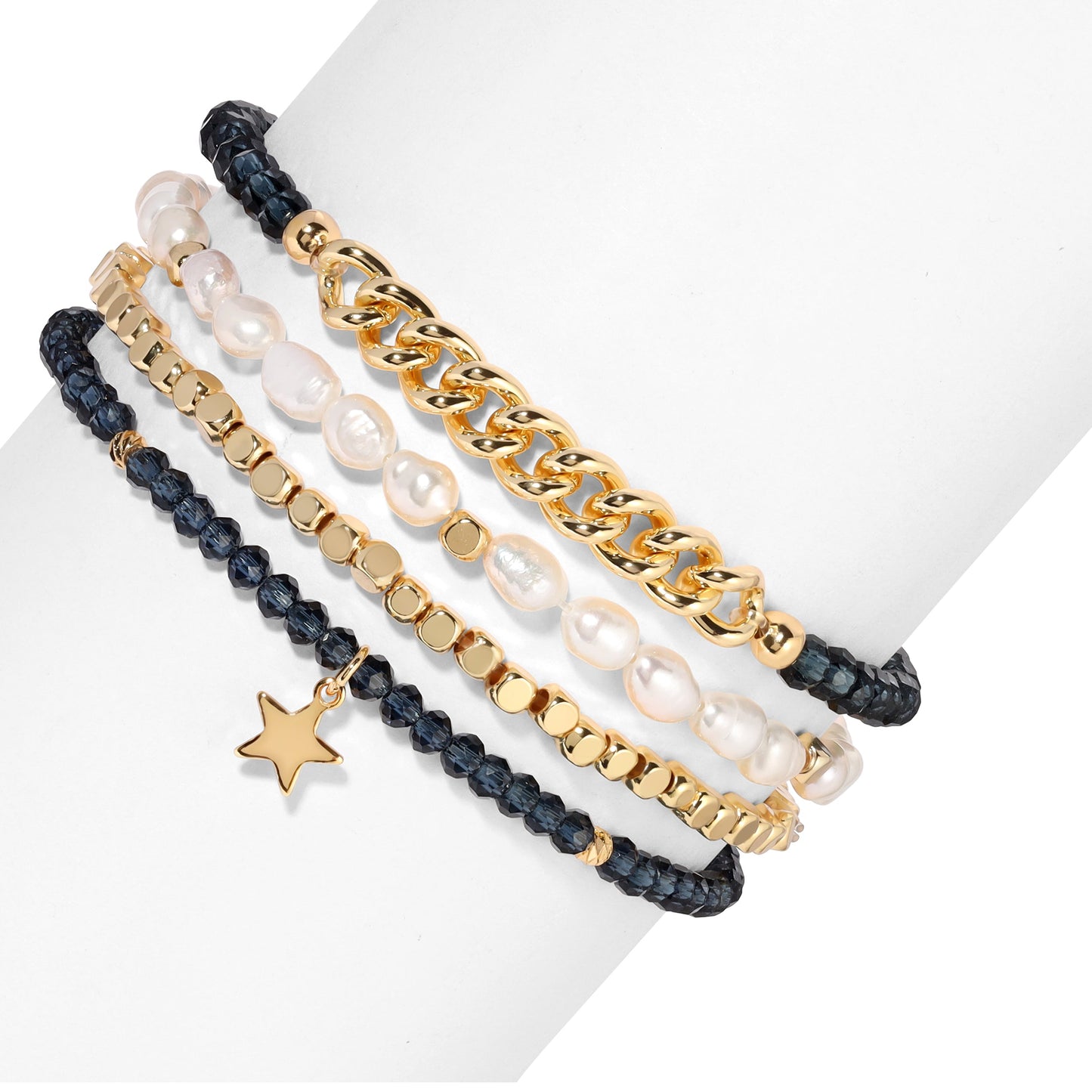 stacked gold and pearl bracelets with star charm
