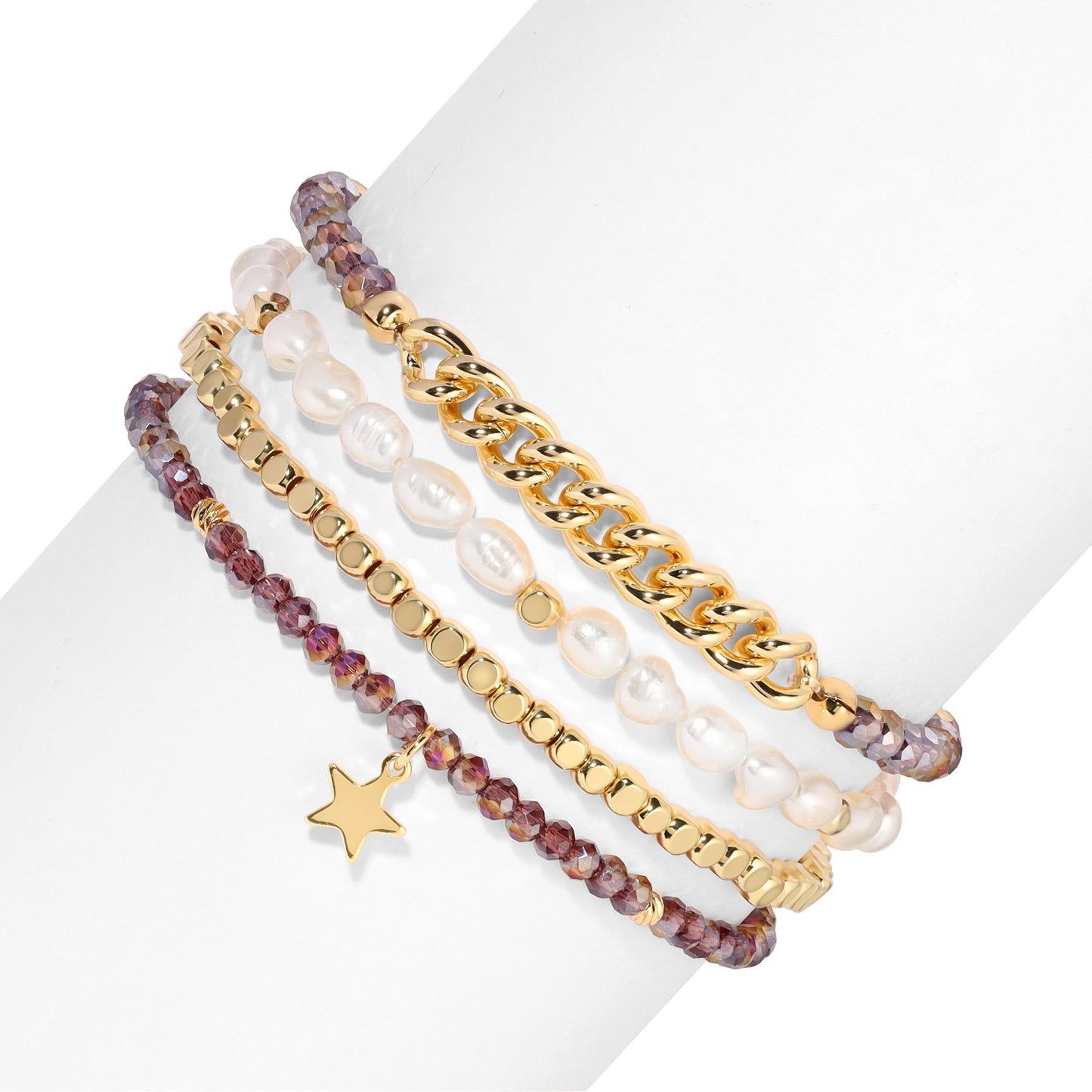 stacked beaded and chain bracelets on white background