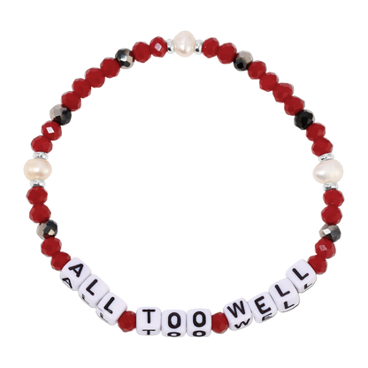 Beaded bracelet with 'All Too Well' message on a white background