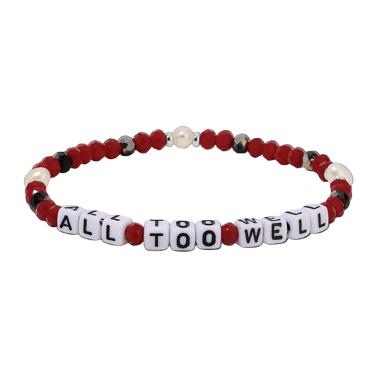 Bracelet with red, white, and black beads spelling 'ALL TOO WELL' on a white background