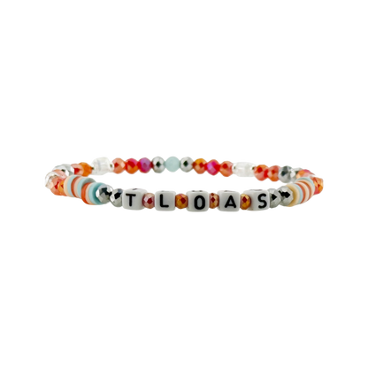 Colorful beaded bracelet with letter beads spelling out 'TLOAS' on a white background
