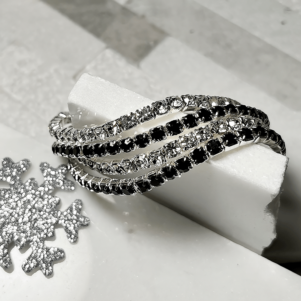 black and silver bracelet on white background