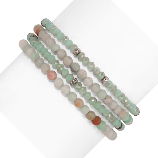 green and white beaded bracelets on white background